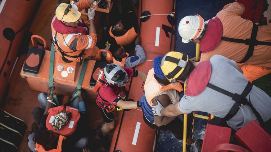 In this image made available Thursday Oct. 27, 2016, by Save The Children, workers with the international charitable organisation Save the Children assist migrants to board the Vos Hestia boat from a  ...