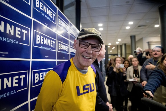 James Carville, a political commentator known for leading former President Bill Clinton&#039;s 1992 presidential campaign, smiles as Democratic presidential candidate Sen. Michael Bennet, D-Colo., bac ...