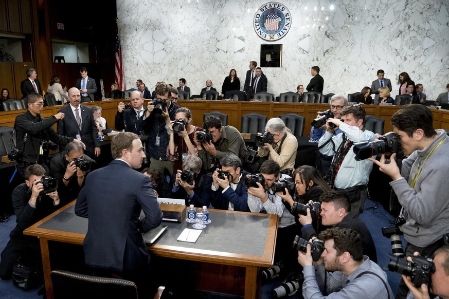 In this April 10, 2018, photo, Facebook CEO Mark Zuckerberg returns from a break as he testifies before a joint hearing of the Commerce and Judiciary Committees on Capitol Hill in Washington. The U.S. ...