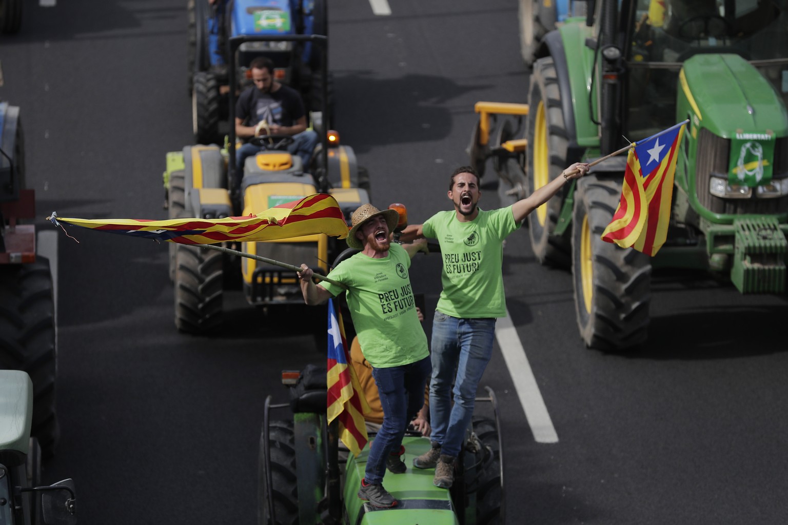 Protesters ride on tractors as they enter the city on the fifth day of protests over the conviction of a dozen Catalan independence leaders in Barcelona, Spain, Friday, Oct. 18, 2019. Various flights  ...