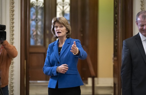 Sen. Lisa Murkowski, R-Alaska, and other senators leave the chamber after voting to recess during the impeachment trial of President Donald Trump on charges of abuse of power and obstruction of Congre ...