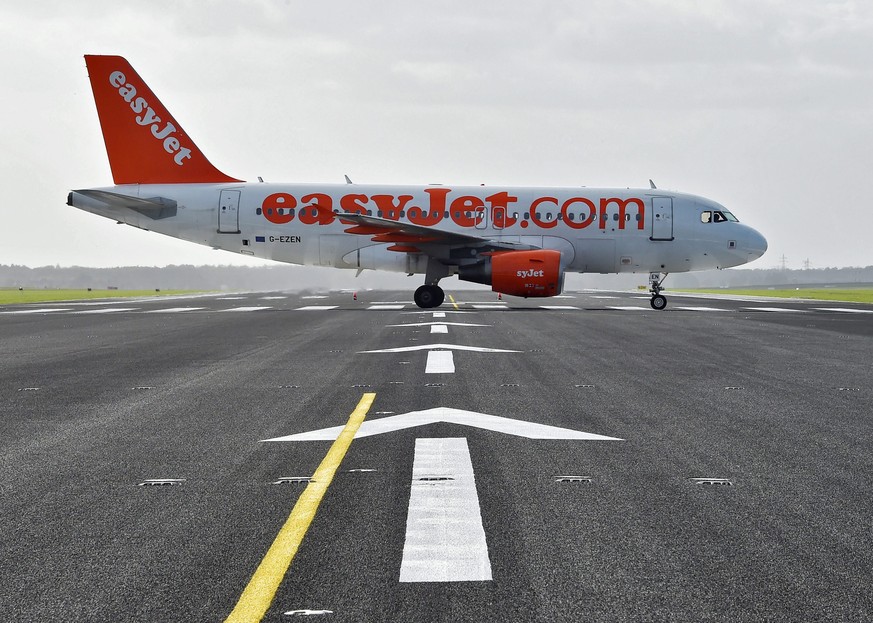 epa05401383 (FILE) A file photo dated 23 October 2015 showing an Airbus A319 of Easyjet crossing the redeveloped northern runway as it taxies to the start on the southern runway of the airfield at Sch ...