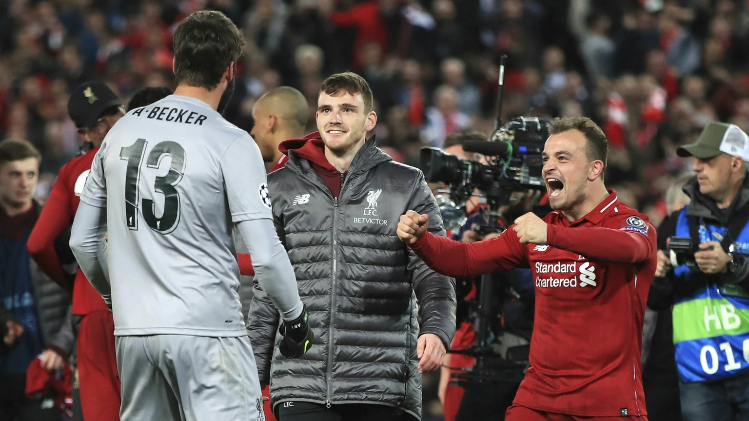 Liverpool&#039;s Xherdan Shaqiri and Alisson Becker celebrate after the Champions League Semi Final, second leg soccer match between Liverpool and Barcelona at Anfield, Liverpool, England, Tuesday, Ma ...