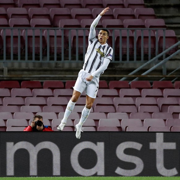 epa08871496 Juventus&#039; striker Cristiano Ronaldo celebrates after scoring the 0-3 from the penalty during the UEFA Champions League group G between FC Barcelona and Juventus at Camp Nou stadium in ...
