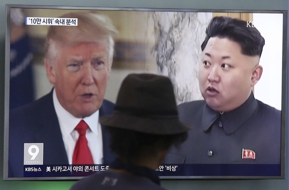 FILE - In this Aug. 10, 2017, file photo, a man watches a television screen showing U.S. President Donald Trump and North Korean leader Kim Jong Un during a news program at the Seoul Train Station in  ...