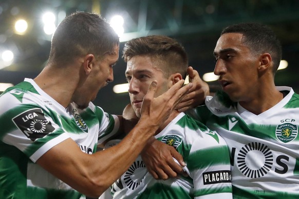 Sporting&#039;s Luciano Vietto is congratulated by teammates Zouhair Feddal Agharbi, left, and Tiago Tomas, right, after scoring his side&#039;s second goal during the Portuguese league soccer match b ...