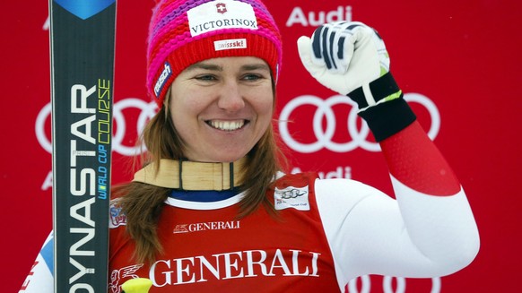 Switzerland&#039;s Fabienne Suter celebrates on the podium after her second place finish following the women&#039;s World Cup downhill ski race in Lake Louise, Alberta, Saturday, Dec. 5, 2015. (Jeff M ...
