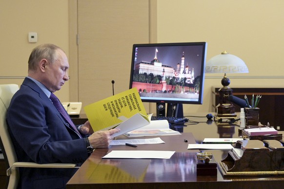 Russian President Vladimir Putin attends a meeting via video conference at the Novo-Ogaryovo residence outside Moscow, Russia, Thursday, April 15, 2021. (Alexei Druzhinin, Sputnik, Kremlin Pool Photo  ...