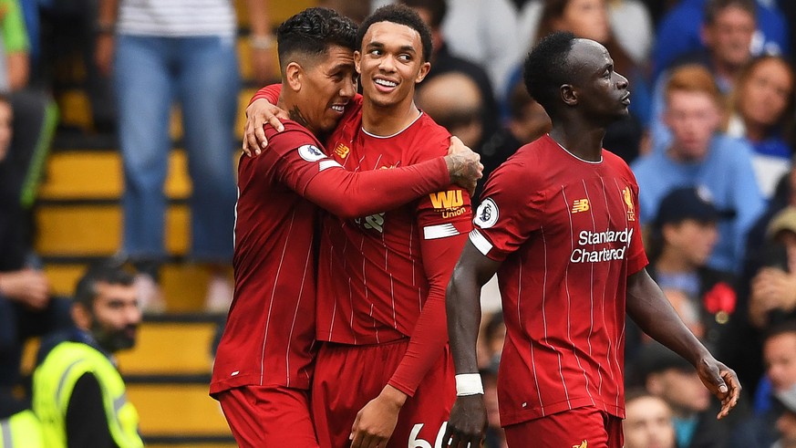 epa07861759 Liverpool&#039;s Roberto Firmino (L) celebrates with teammate Trent Alexander-Arnold (C) after scoring the 2-0 lead during the English Premier League soccer match between Chelsea FC and Li ...