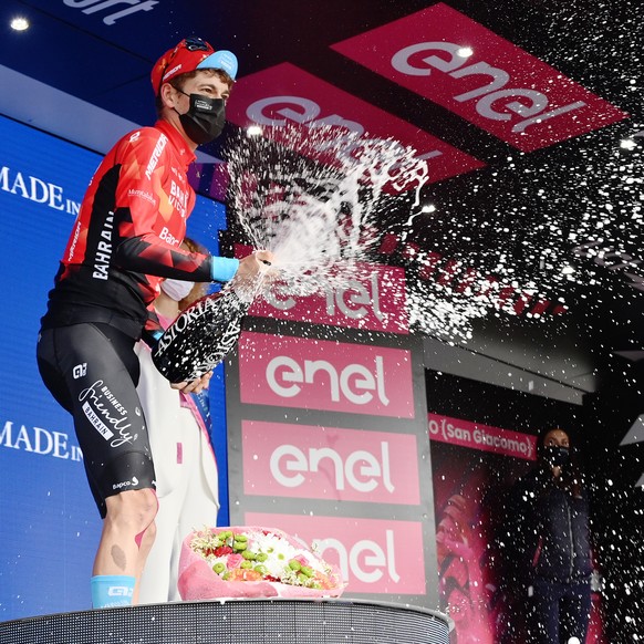 Switzerland&#039;s Gino Mader celebrates on the podium after winning the sixth stage of the Giro d&#039;Italia cycling race, from Grotte di Frasassi to Ascoli Piceno Thursday, May 13, 2021. (Gian Matt ...