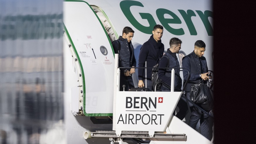 Juventus Torino players step off their aircraft, from right, Emre Can, Miralem Pjanic and Cristiano Ronaldo and Mattia De Sciglio, after the arrival at the airport in Bern, Switzerland, Tuesday, Dec.  ...