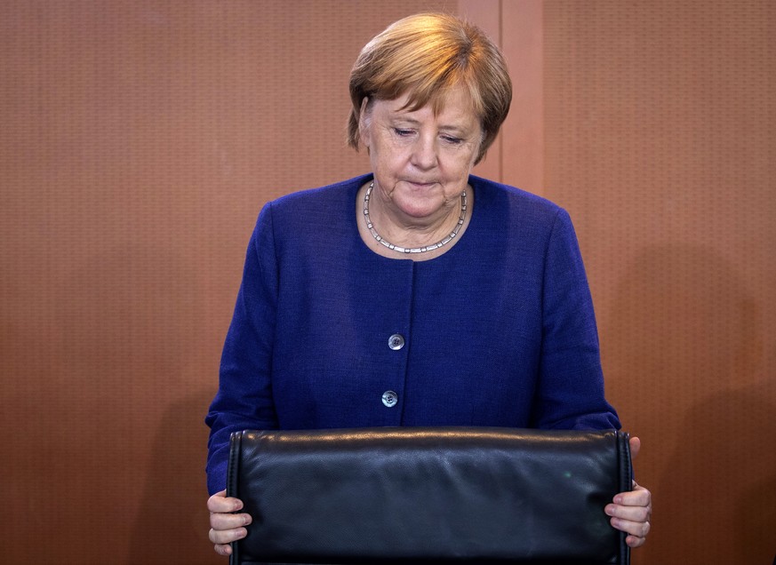 German Chancellor Angela Merkel takes her seat prior to the weekly cabinet meeting in Berlin Wednesday, Sept. 26, 2018. (Kay Nietfeld/dpa via AP)