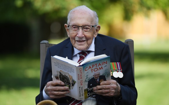 epa08675173 Captain Sir Tom Moore poses for photographers to promote the launch of his book &#039;Tomorrow is a Good Day&#039; at his home in Bedfordshire, Britain, 17 September 2020. In April 2020 Mo ...