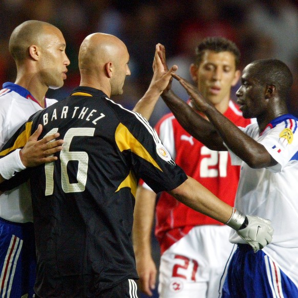 France&#039;s Mikael Silvestre, left, Fabien Barthez and Claude Makalele embrace after their 3-1 win over Switzerland in a Group B Euro 2004 first round match at the Cidade de Coimbra Stadium, in Coim ...