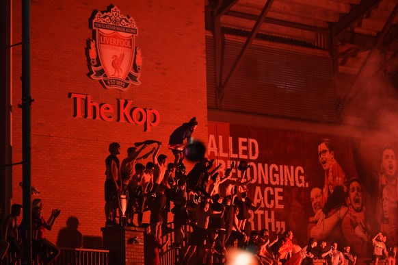 epaselect epa08509755 Ecstatic Liverpool FC celebrate outside Anfield stadium in Liverpool, Britain, 25 June 2020. Liverpool have been crowned champions of the Premier League for the first time in thr ...