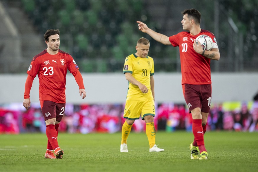 Switzerland&#039;s Xherdan Shaqiri, left, speaks with Granit Xhaka during the FIFA World Cup Qatar 2022 qualifying Group C soccer match between Switzerland and Lithuania, at the kybunpark stadium in S ...