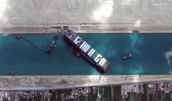 This satellite image from Maxar Technologies shows the cargo ship MV Ever Given stuck in the Suez Canal near Suez, Egypt, Sunday, March 28, 2021. Two additional tugboats sped Sunday to Egypt&#039;s Su ...