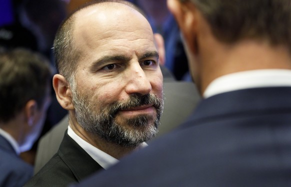epa07561260 Uber CEO Dara Khosrowshahi (L) and Ryan Graves (R), one of the co-founders of Uber, talk on the floor of the New York Stock Exchange while waiting for today&#039;s initial public offering  ...