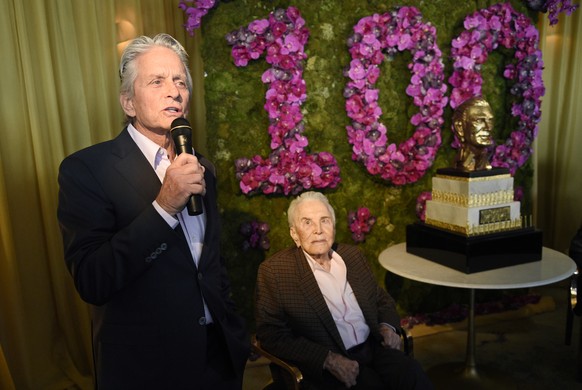 Michael Douglas, left, speaks about his father Kirk Douglas, during Kirk&#039;s 100th birthday party at the Beverly Hills Hotel on Friday, Dec. 9. 2016, in Beverly Hills, Calif. (Photo by Chris Pizzel ...