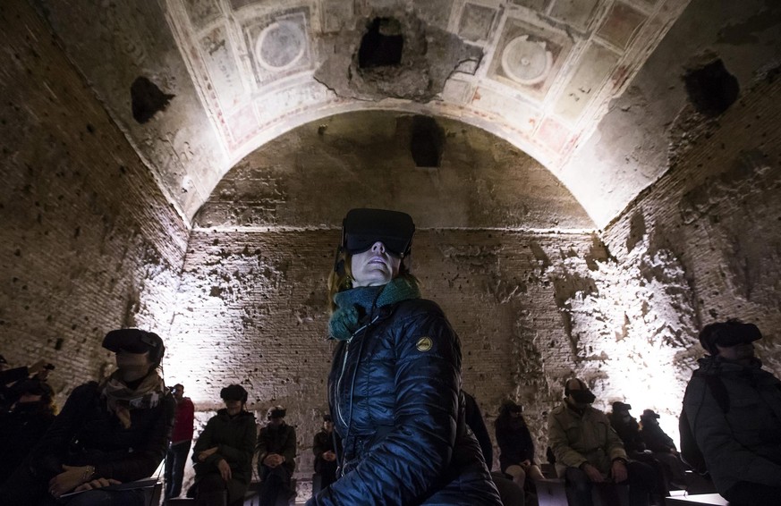 epa05762885 Visitors wear virtual reality goggles at the Domus Aurea archeological restoration site in Rome, Italy, 31 January 2017. Starting from 04 February 2017, the site will reopen to the public  ...
