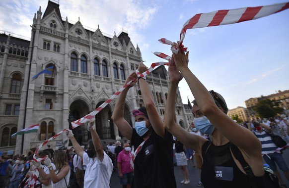 Students of the University of Theatre and Film Arts (SZFE) and their sympathizers form a human chain in protest against changes to the way the university is governed in Budapest, Hungary, Sunday, Sept ...
