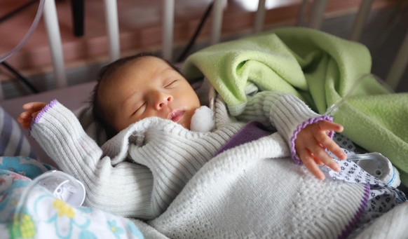 epa08418721 A rescued newborn baby takes medical care in a hospital a day after the complex attack at MSF (Doctors without Borders) hospital, in Kabul, Afghanistan, 13 May 2020. According to reports,  ...