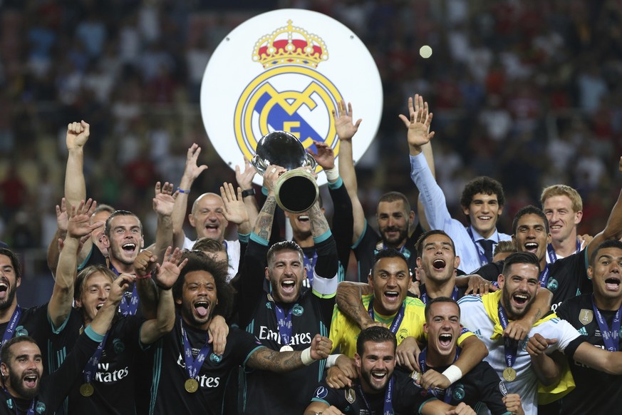 Real Madrid celebrate with the trophy after defeating Manchester United 2-1 during the Super Cup final soccer match at Philip II Arena in Skopje, Tuesday, Aug. 8, 2017. (AP Photo/Boris Grdanoski)