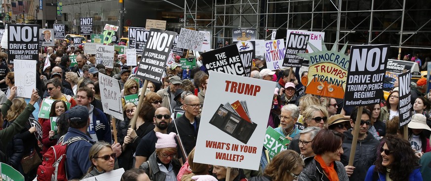 epa05910137 Protesters march toward Trump Tower calling for US President Donald J. Trump to release his tax returns to the public in New York, New York, USA, 15 March 2017. Traditionally 15 April is t ...