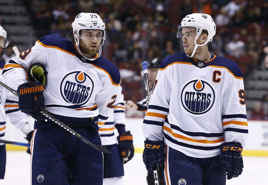 FILE - In this Jan. 12, 2018, file photo, Edmonton Oilers center Connor McDavid, right, talks with Oilers center Leon Draisaitl (29) during the first period of an NHL hockey game against the Arizona C ...