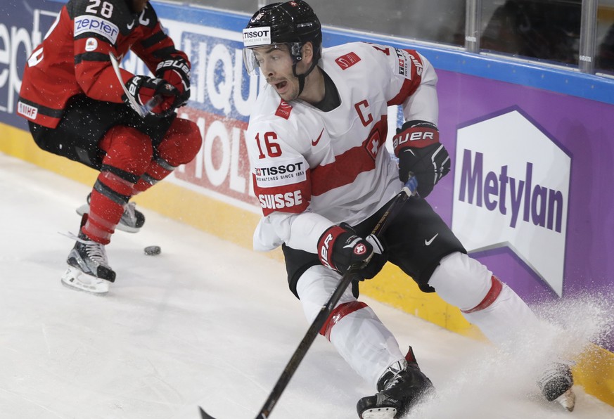 Canada&#039;s Claude Giroux, left, challenges for the puck Switzerland&#039;s Raphael Diaz, right, during the Ice Hockey World Championships group B match between Canada and Switzerland in the AccorHo ...