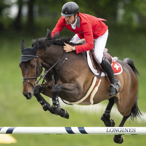 epa09250665 Steve Guerdat of Switzerland and horse Venard de Cerisy take an obstacle at the Longines FEI Jumping Nations Cup of Switzerland during the CSIO Show Jumping in St. Gallen, Switzerland, 06  ...