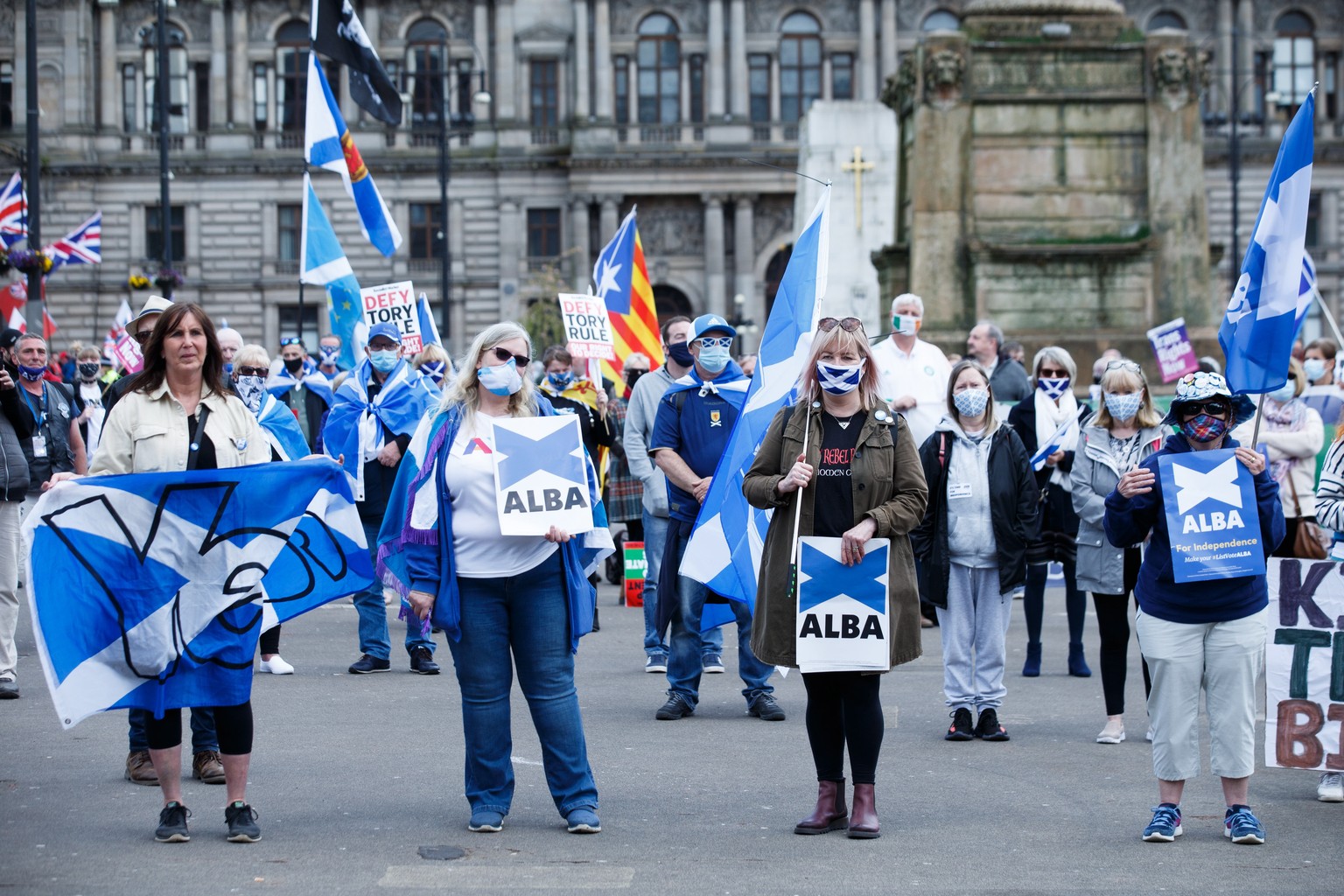 epa09171738 People attend a pro-independence rally held by independence pressure group All Under One Banner (AUOB) in George Square, Glasgow, Scotland, 01 May 2021. The group rallies for another refer ...