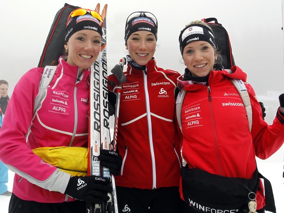 Switzerland&#039;s sisters Selina, left, Aita, center, and Elisa Gasparin pose at the end of a women&#039;s Biathlon 4x6 kilometer relay race in Anterselva, Italy, Sunday, Jan. 19, 2014. The race was  ...