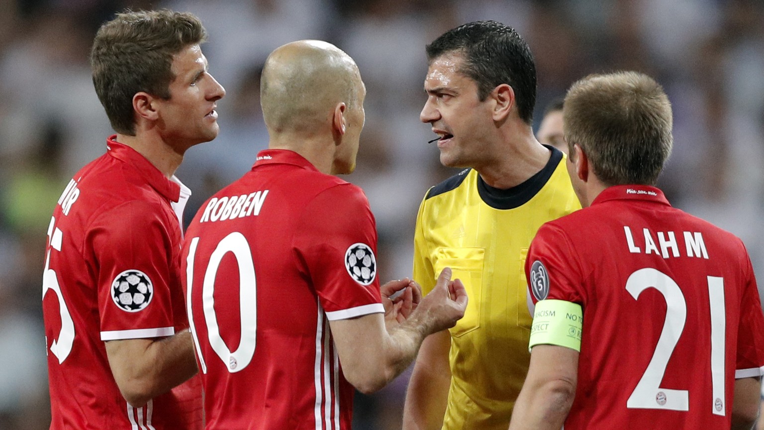 Bayern players argue with Referee Viktor Kassai after he showed a second yellow card to Arturo Vidal, left, during the Champions League quarterfinal second leg soccer match between Real Madrid and Bay ...