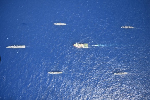 FILE - In this photo provided by the Turkish Defense Ministry on Aug 10, 2020, Turkey&#039;s research vessel, Oruc Reis, in red and white, is surrounded by Turkish navy vessels as it was heading in th ...
