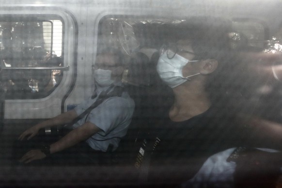 Former Studentlocalism leader Tony Chung arrives at a court on a police van after he was arrested under the national security law, in Hong Kong, Thursday, Oct. 29, 2020. Chung, former leader of Hong K ...