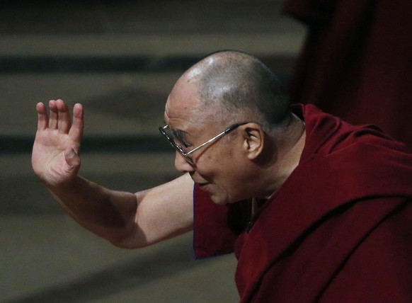His Holiness the Dalai Lama waves good bye after his speech and at the National Cathedral in Washington March 7, 2014. 
 REUTERS/Gary Cameron (UNITED STATES - Tags: RELIGION POLITICS)