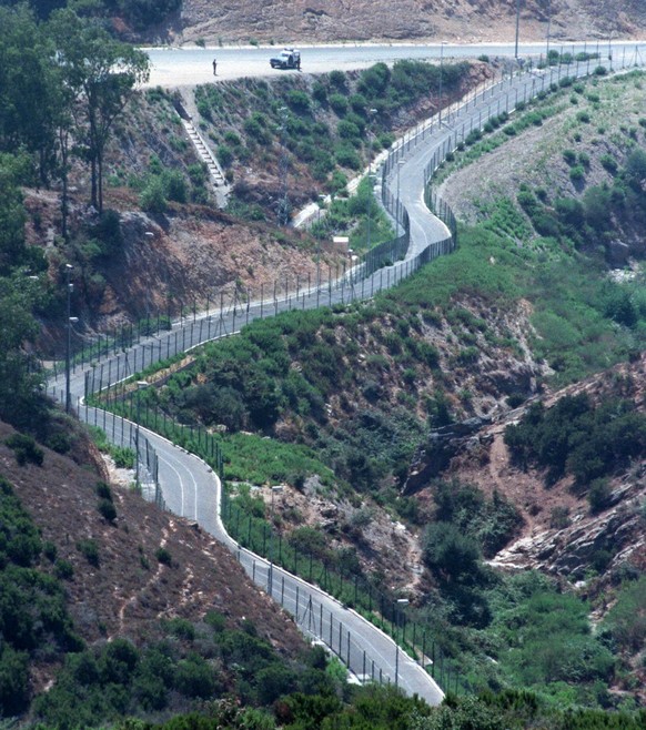 The newly-built fences on the border between the Spanish enclave of Ceuta and Morocco, snake through the countryside August 20, 1998. The new border &quot;walls&quot; will be completely finished by th ...