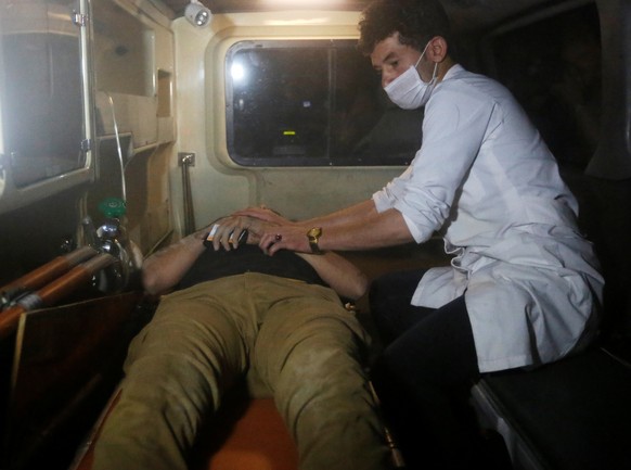 A wounded man lies inside an ambulance following an attack at American University of Afghanistan in Kabul, Afghanistan August 24, 2016. REUTERS/Omar Sobhani