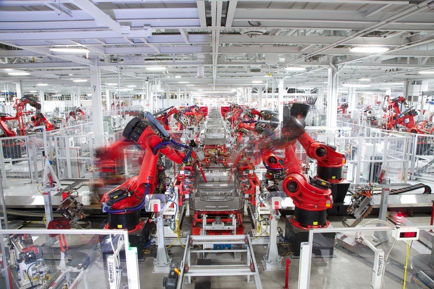 epa06064183 In this handout photo made available by Tesla Motors on 03 July 2017 shows robotics at work on a Telsa car at the Fremont Factory in Fremont, California, USA, 23 April 2013. EPA/HANDOUT HA ...