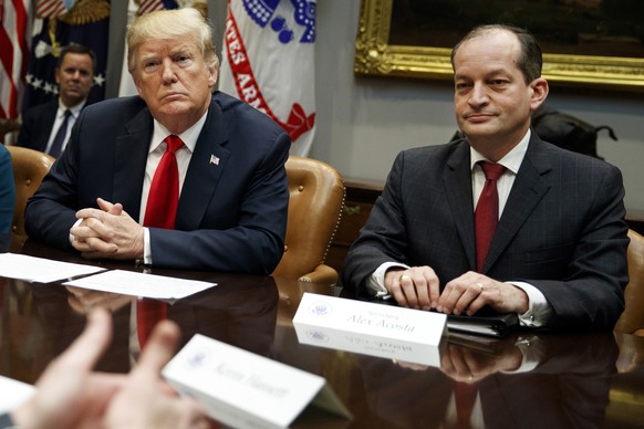 FILE - In this Sept. 17, 2018, file photo, President Donald Trump, left, and Labor Secretary Alexander Acosta listen during a meeting of the President&#039;s National Council of the American Worker in ...