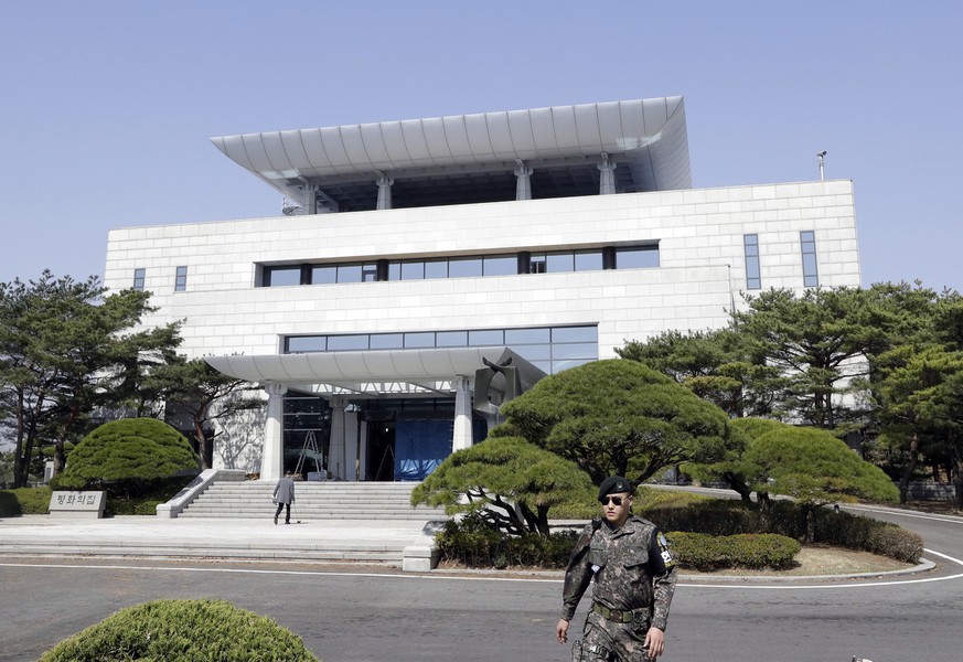 In this April 18, 2018 photo, a South Korean soldier walks outside of the Peace House, the venue for the planned summit between South Korean President Moon Jae-in and North Korean leader Kim Jong Un o ...