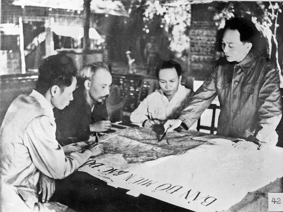 In this 1954 photo, President Ho Chi Minh, second from left, and other Communist Party and government leaders including General Vo Nguyen Giap, right, discuss plan for Dien Bien Phu Campaign. ** Edito ...