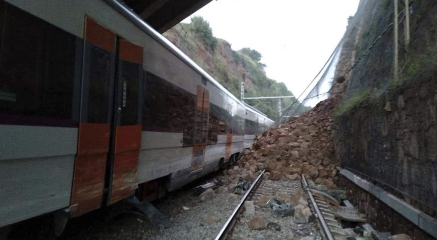 A landslide collides with a passenger train, near Vacarisses, some 45 kilometers northwest of Barcelona, Spain, Tuesday Nov. 20, 2018. One person died and dozens were injured Tuesday after a landslide ...
