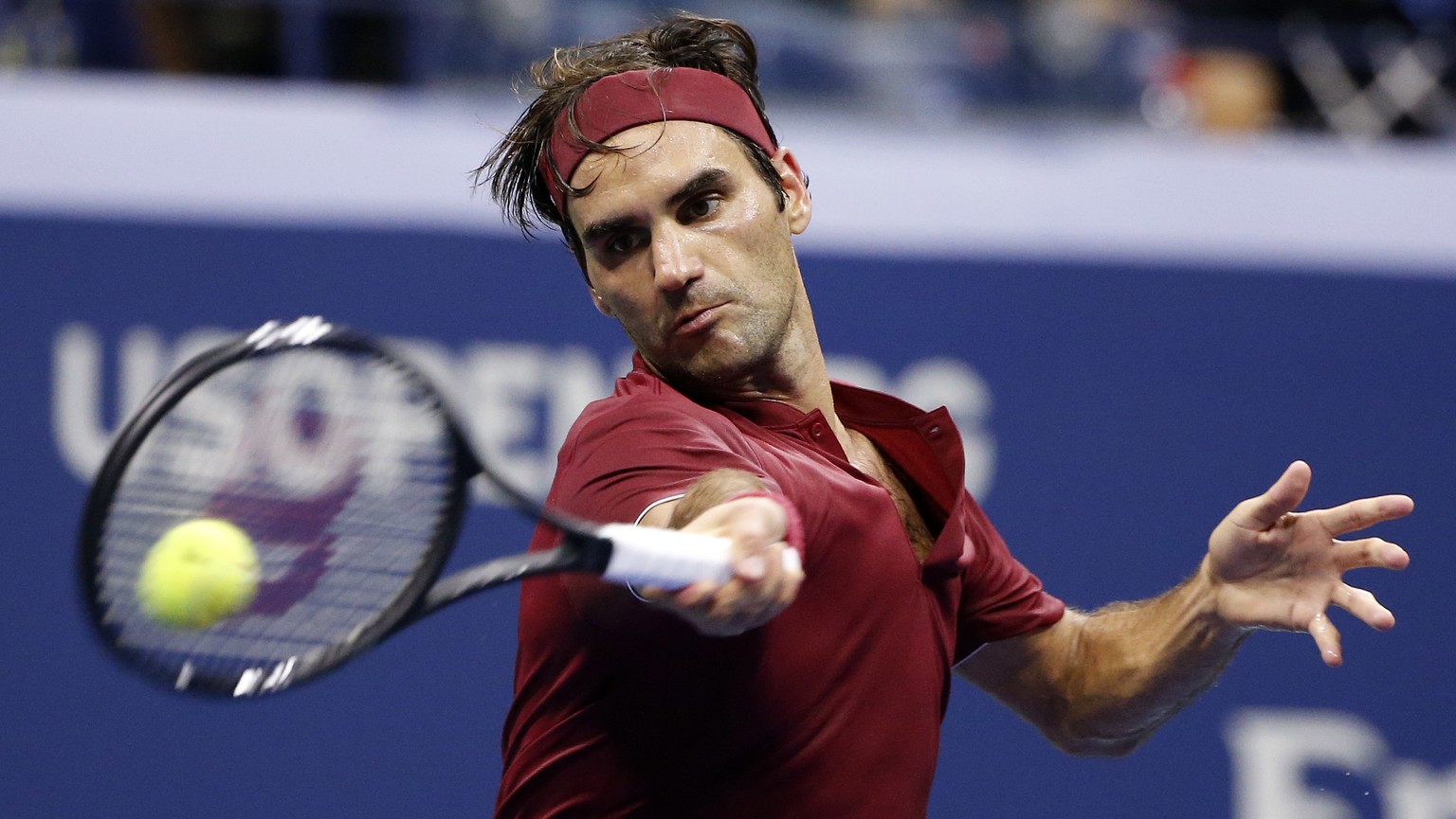 Roger Federer, of Switzerland, returns a shot to John Millman, of Australia, during the fourth round of the U.S. Open tennis tournament early Tuesday, Sept. 4, 2018, in New York. (AP Photo/Jason DeCro ...