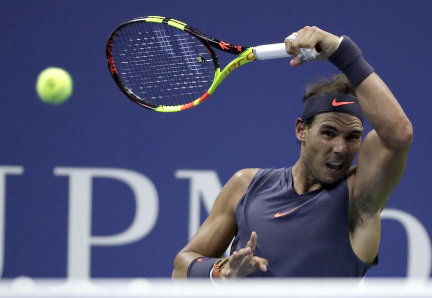 Rafael Nadal, of Spain, follows through on a forehand to Vasek Pospisil, of Canada, during the second round of the U.S. Open tennis tournament Wednesday, Aug. 29, 2018, in New York. (AP Photo/Julio Co ...