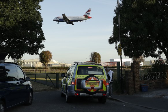 A police vehicle sits on patrol near Heathrow Airport in London, as a plane comes in to land, Friday, Sept. 13, 2019. An environmental group called Heathrow Pause planned to disrupt Heathrow with dron ...