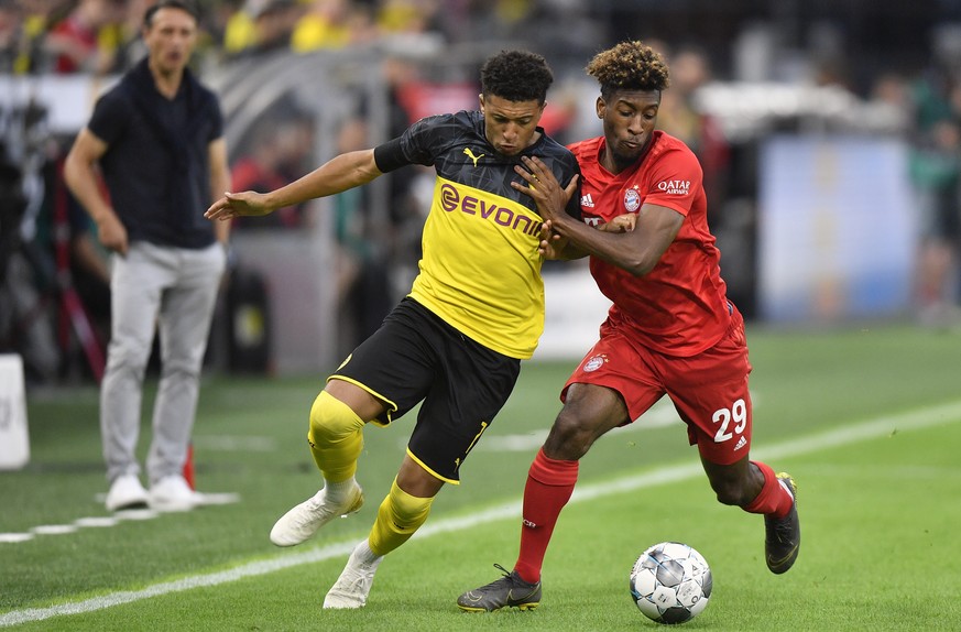Bayern&#039;s Kingsley Coman, right, duels for the ball with Dortmund&#039;s Jadon Sancho during the German Supercup final soccer match between Borussia Dortmund and Bayern Munich in Dortmund, Germany ...