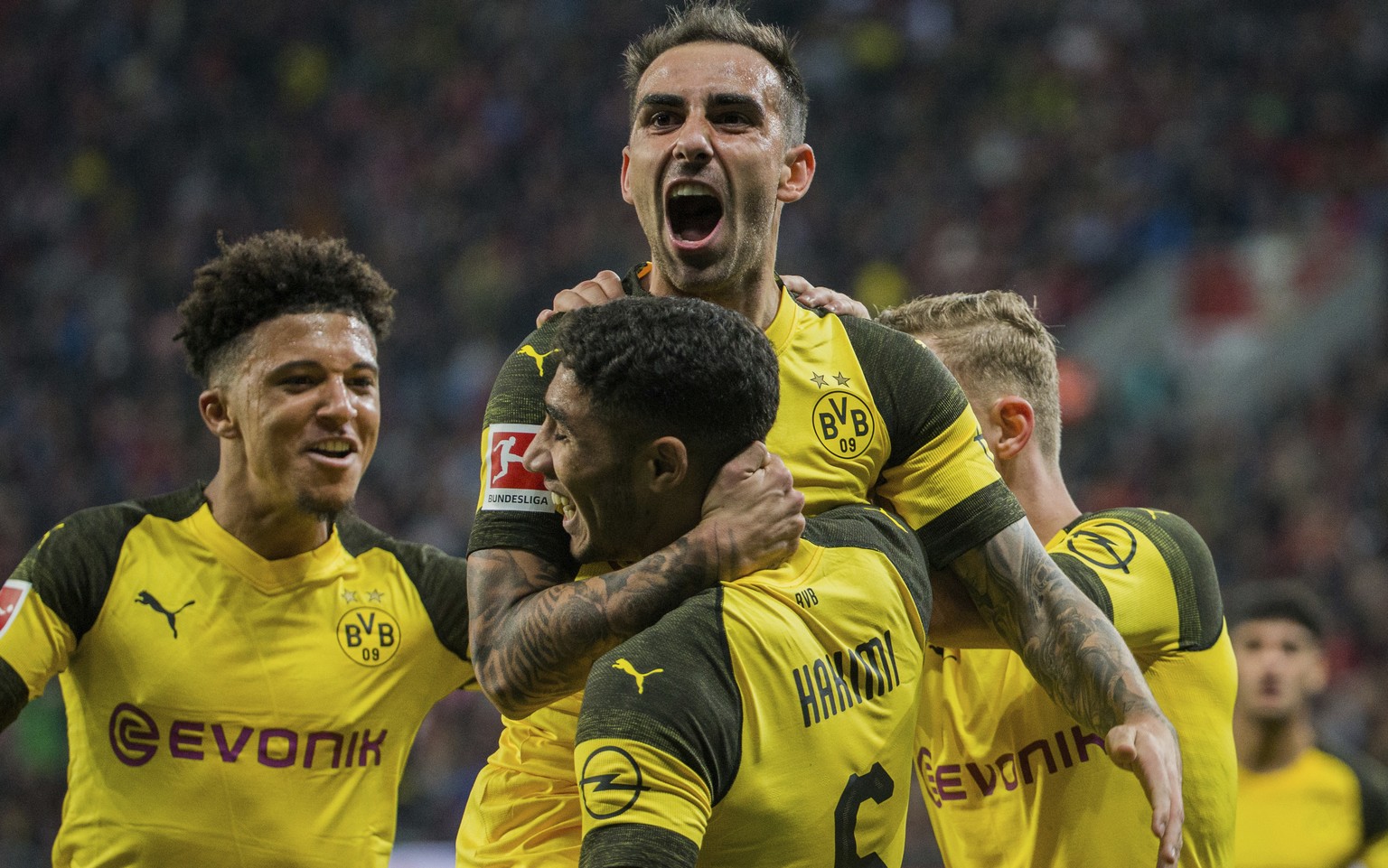 In this Sept. 29, 2018 photo Dortmund&#039;s Paco Alcacer, top, celebrates with Achraf Hakim, front, and Jadon Sancho after scoring his side&#039;s third goal in the German Bundesliga soccer match bet ...