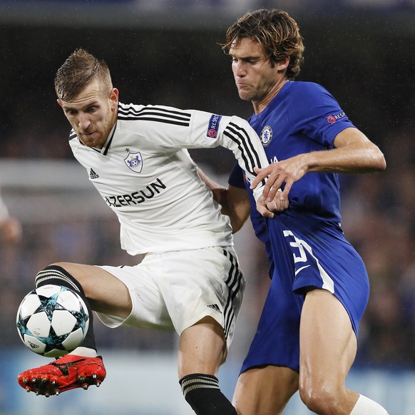 Qarabag&#039;s Pedro Henrique, left, challenges for the ball with Chelsea&#039;s Marcos Alonso during the Champions League group C soccer match between Chelsea and Qarabag at Stamford Bridge stadium i ...